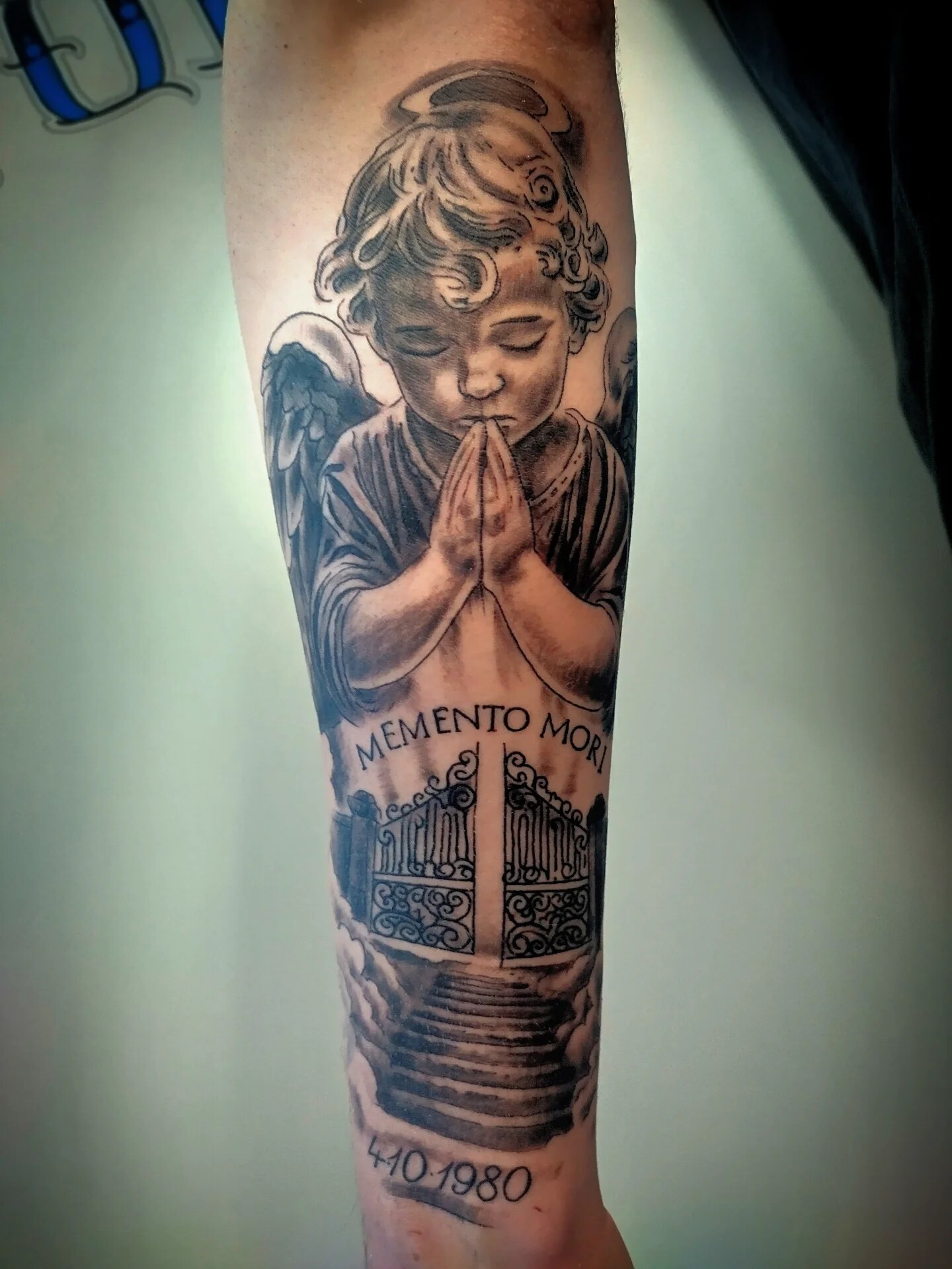 Praying cherub with Memento Mori gates black and grey sleeve