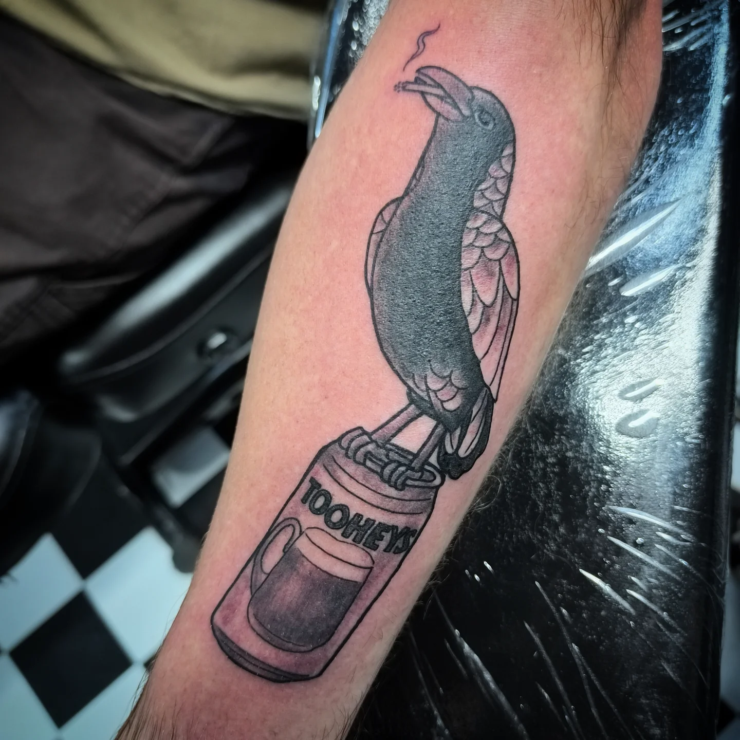 Black and grey crow smoking on a Tooheys beer can Aussie tattoo