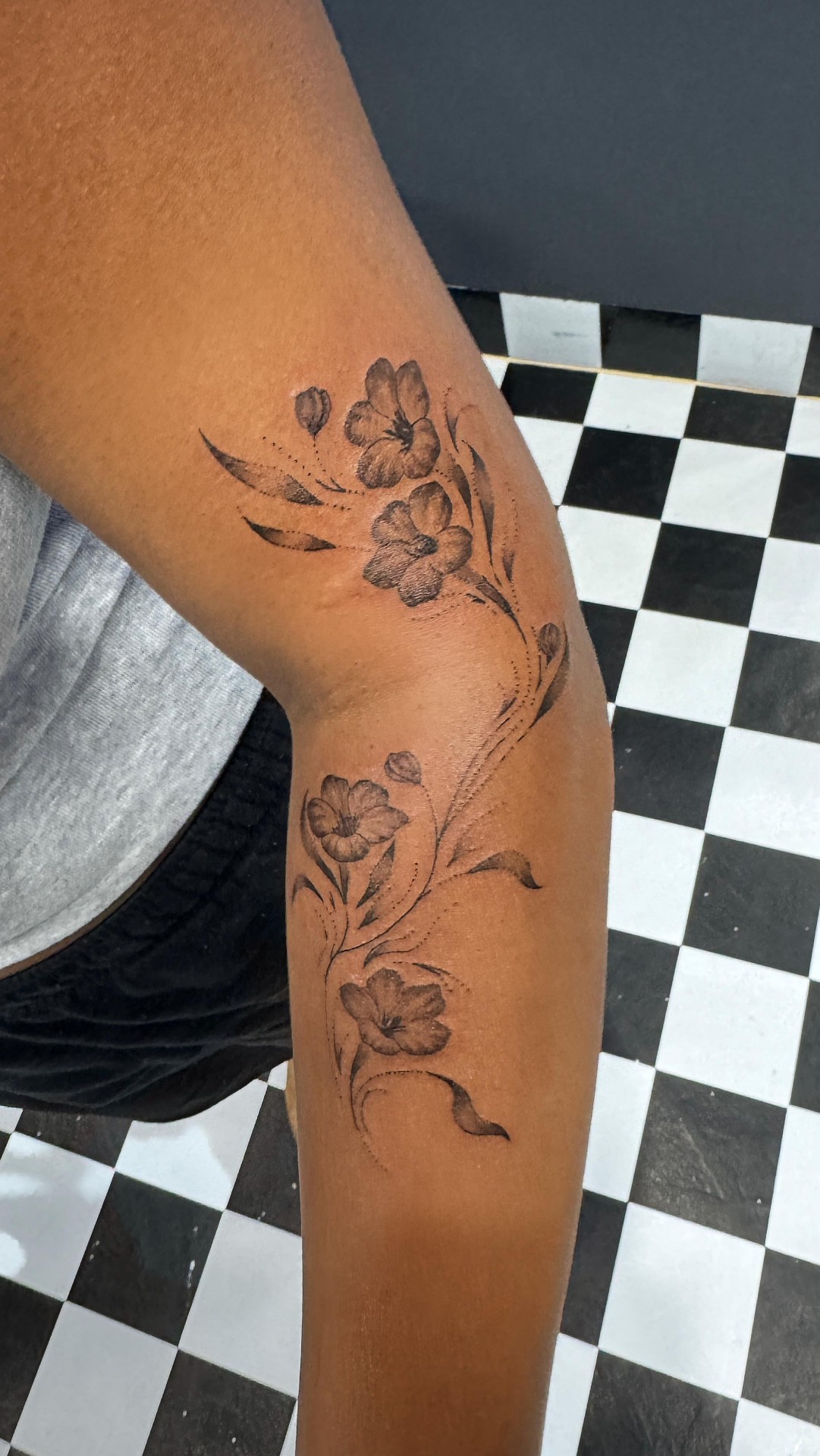 Fine line floral leg tattoo with poppies